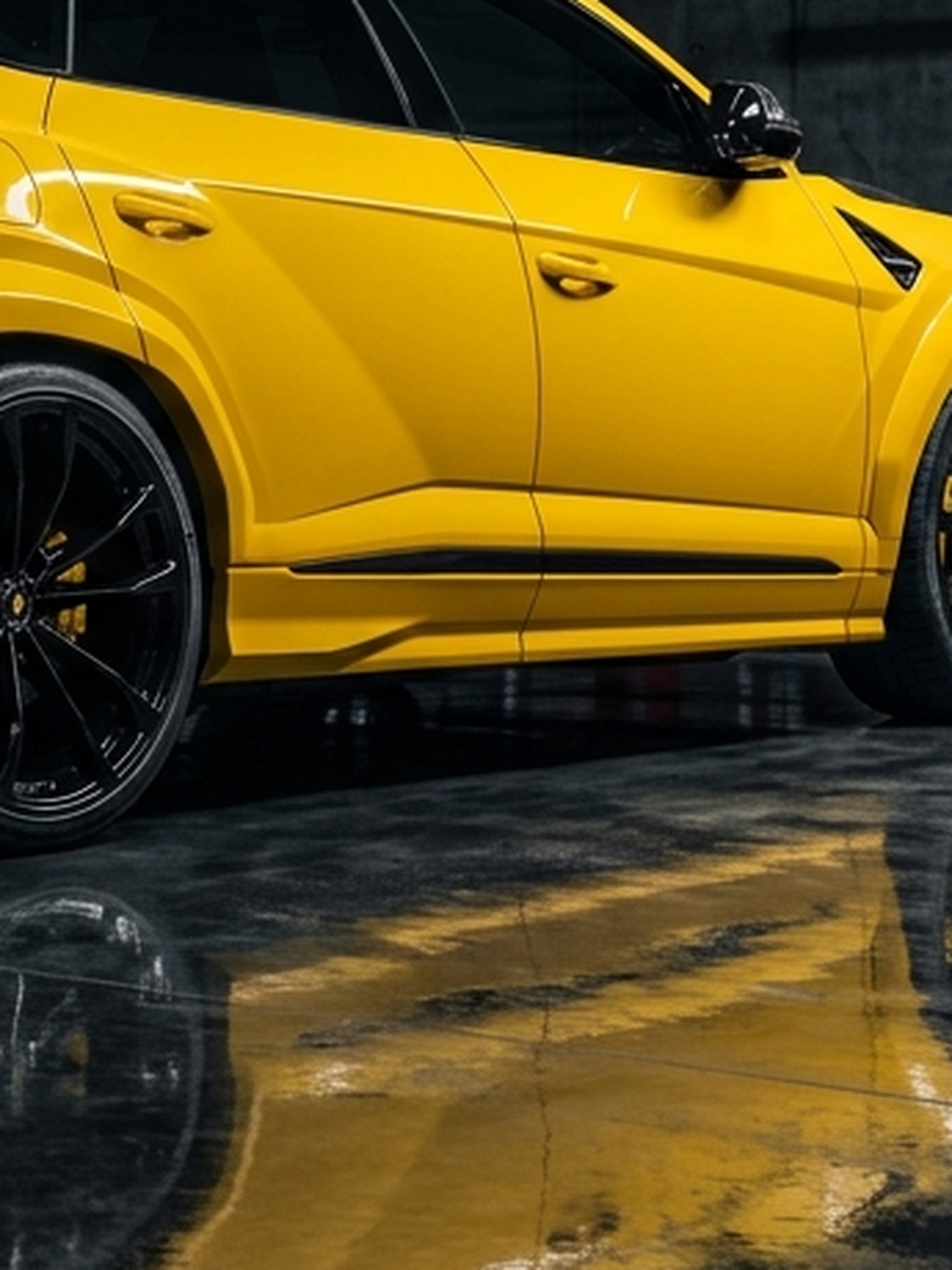 A custom Branders Lamborghini Urus parked on a bright workshop floor, viewed from above at the rear.