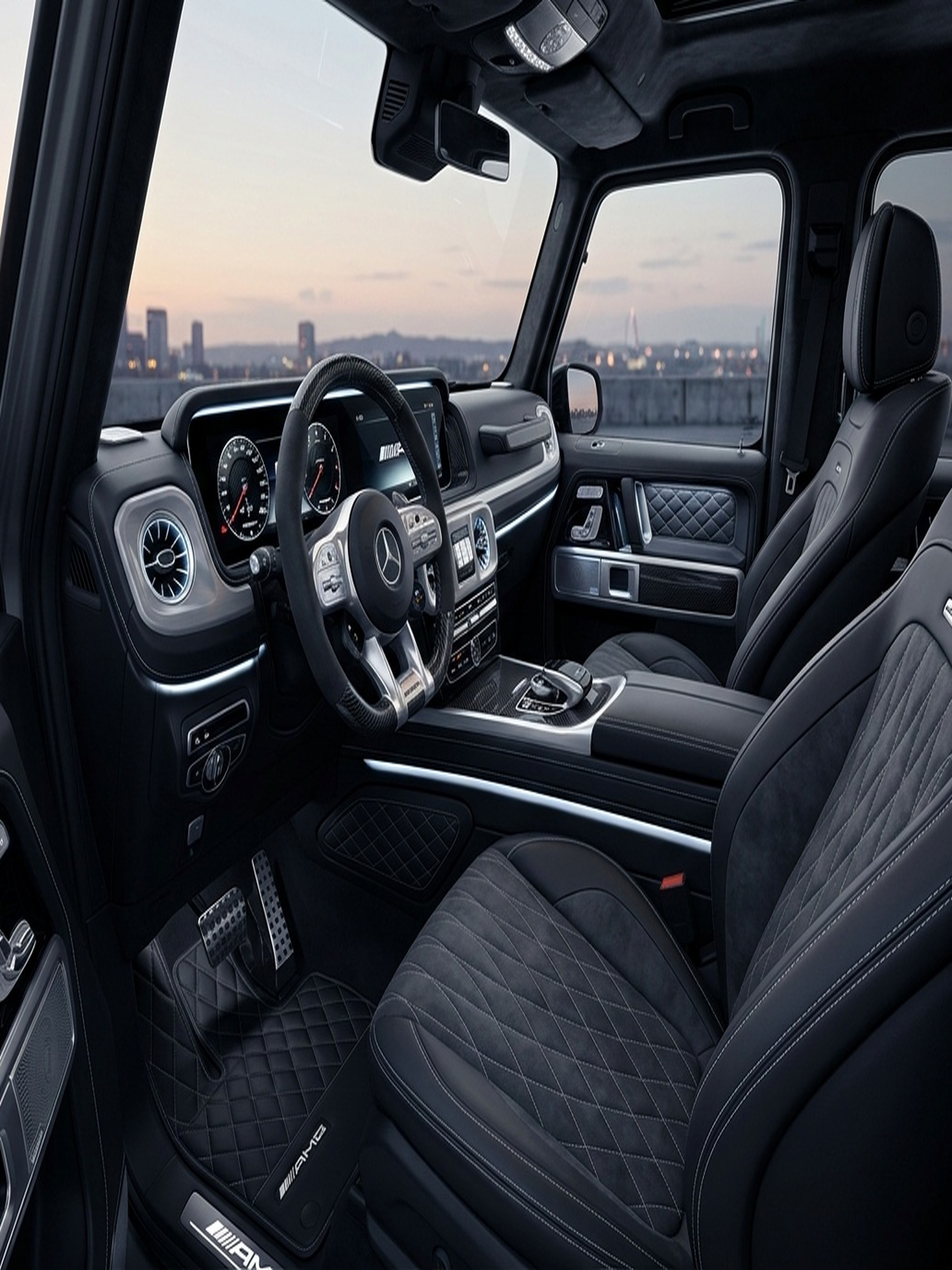 An open rear door of a custom Branders Mercedes G63 reveals diamond-quilted tan leather interior lining and trim.