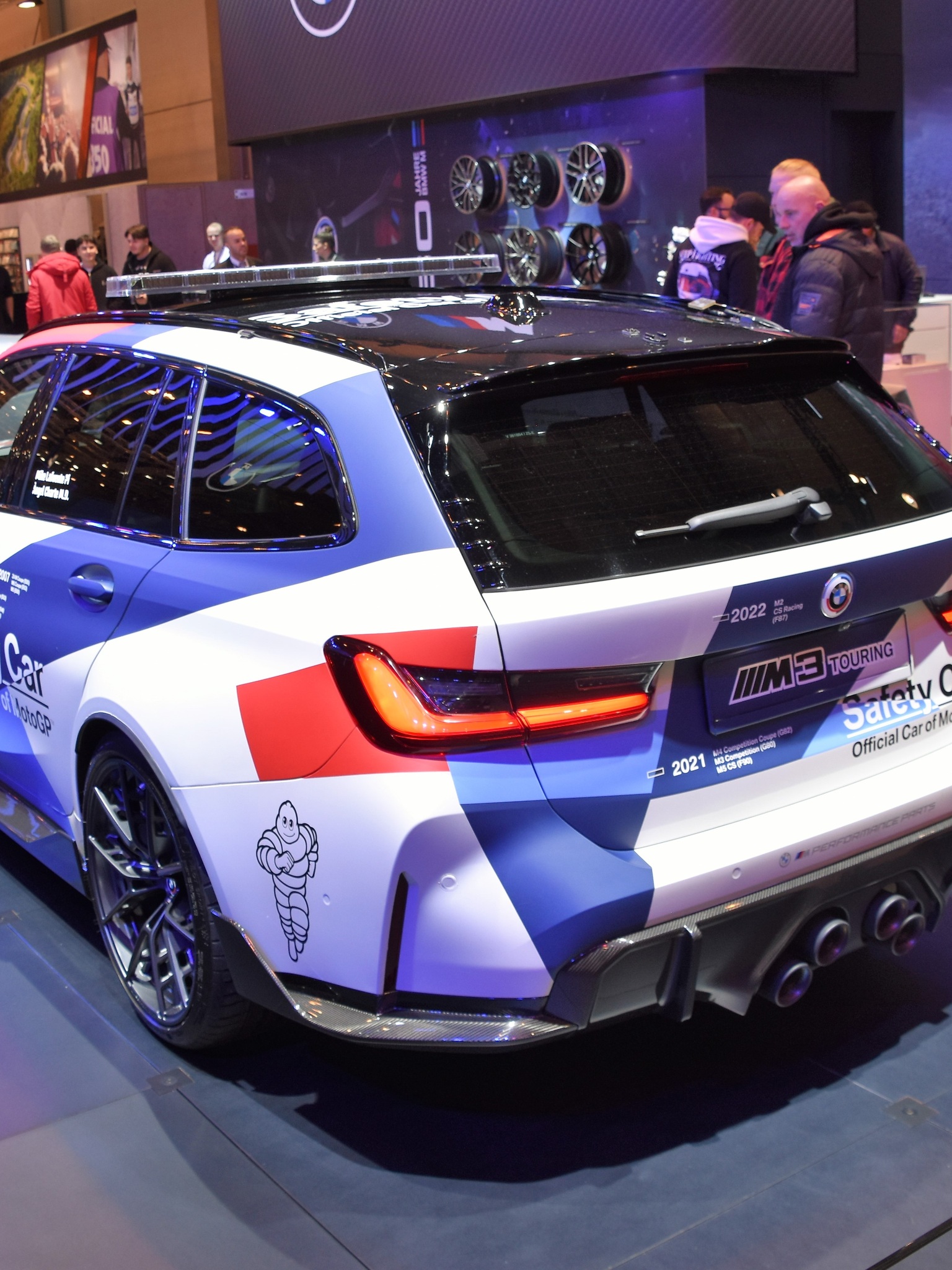 A custom Branders BMW M5 Touring sits parked on lifts inside a brightly lit detailing workshop.