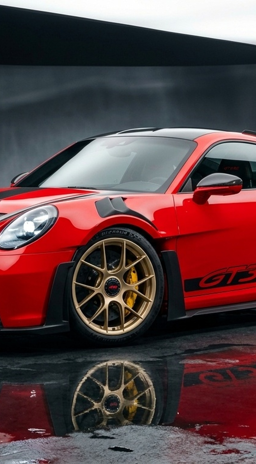 A custom Branders Porsche 911 Carrera Turbo with illuminated headlights parked on a wet concrete floor in a modern brutalist building with glowing stairs.