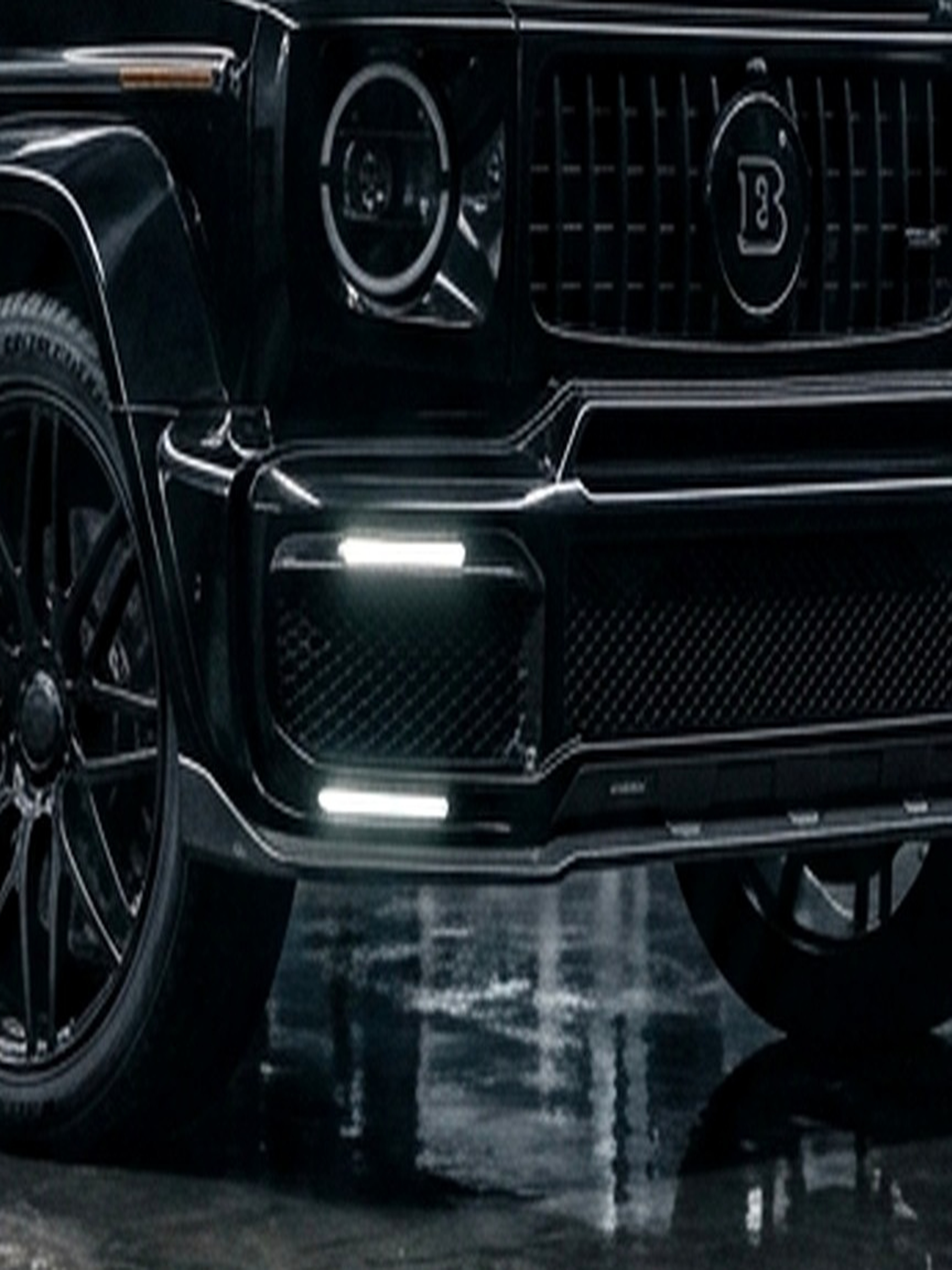 An open door of a custom Branders Mercedes G63 reveals a tan leather interior and a sunroof.